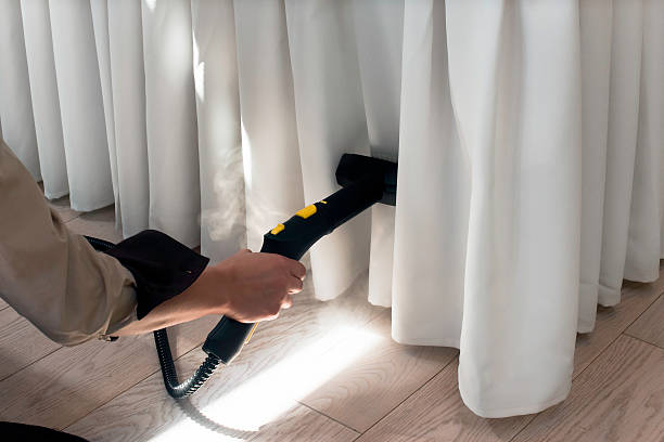 garment steamer ironing the tablecloth